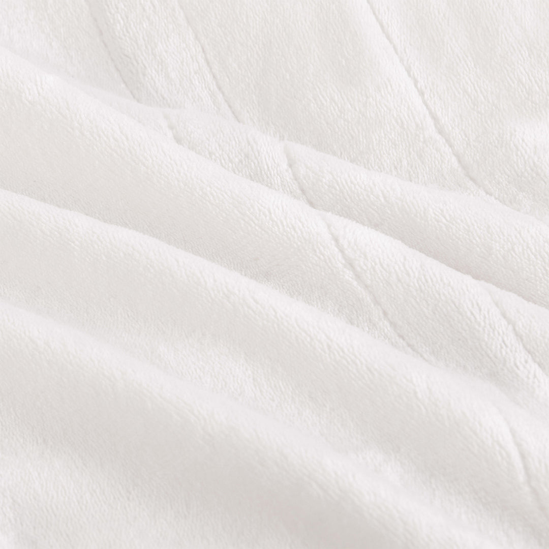 Close-up texture of the ivory oversized heated throw.