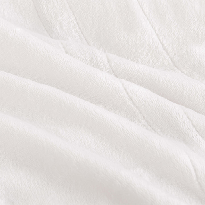Close-up texture of the ivory oversized heated throw.