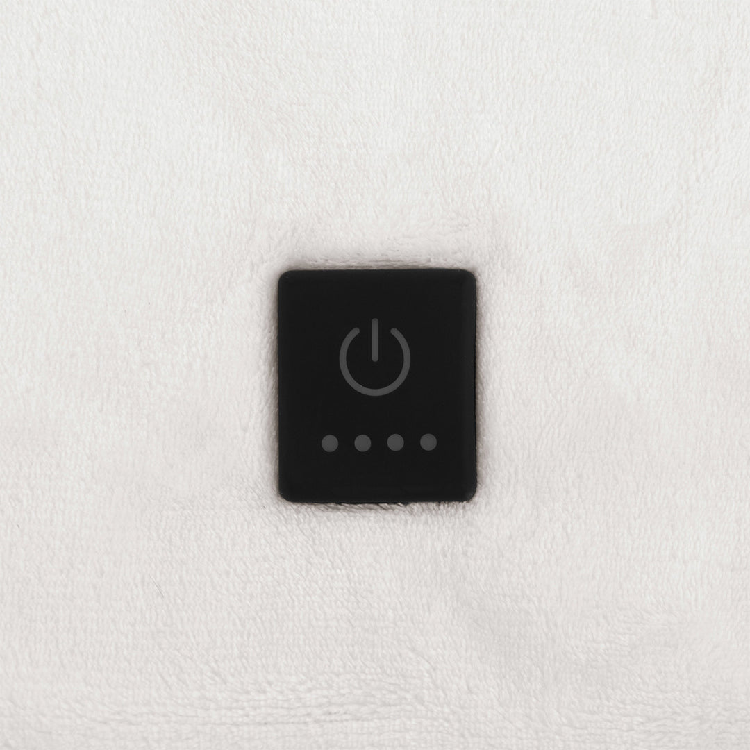 Built-in control button on ivory oversized heated throw.