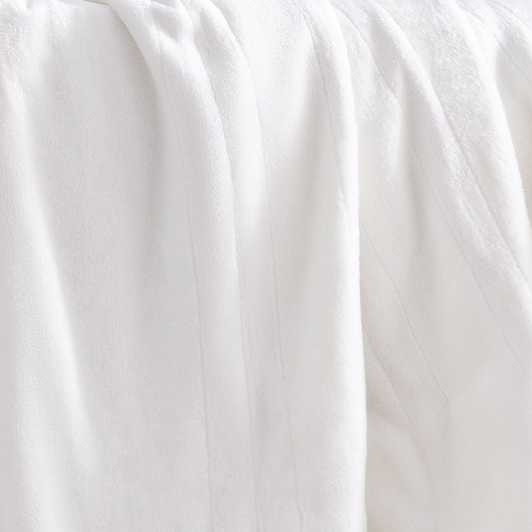 Close-up of the ivory oversized heated throw showing its soft, plush texture.