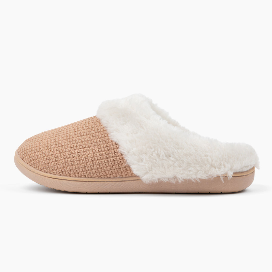 Beige slipper with white fur lining on a white background