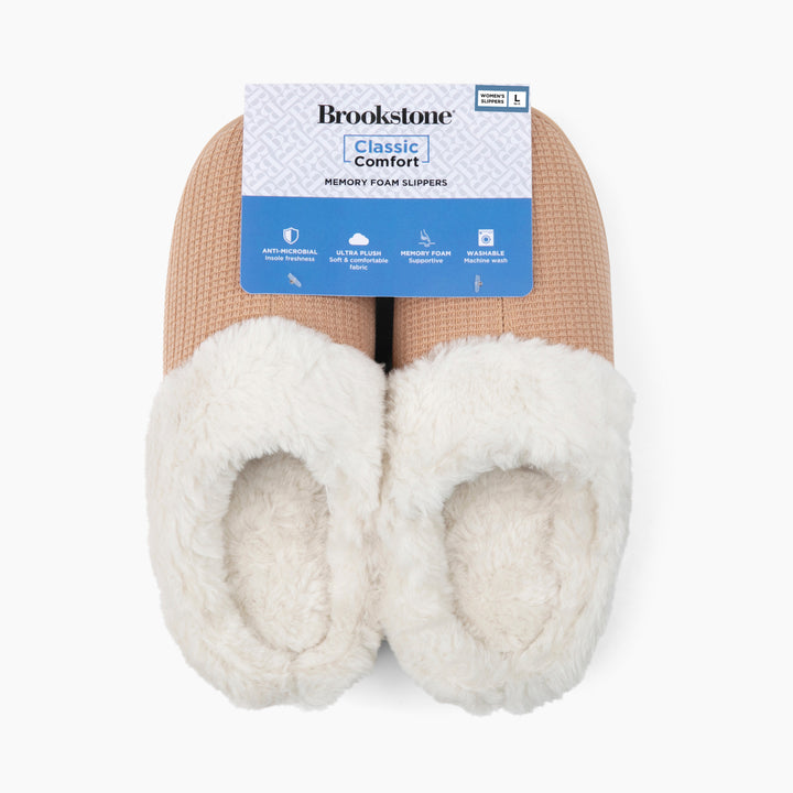 Pair of white memory foam slippers with a Brookstone label on a white background