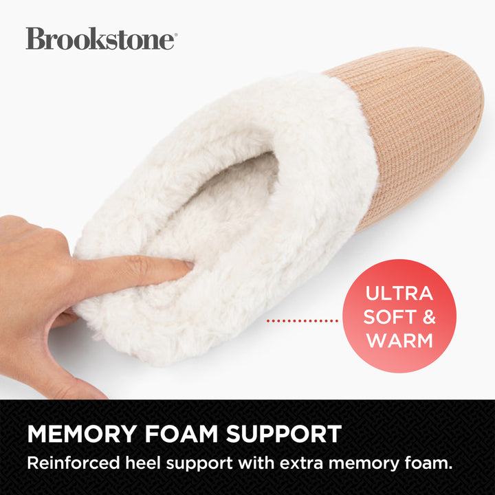 Beige slipper with white fur lining, held by a hand, on a white background with 'Brookstone' branding.