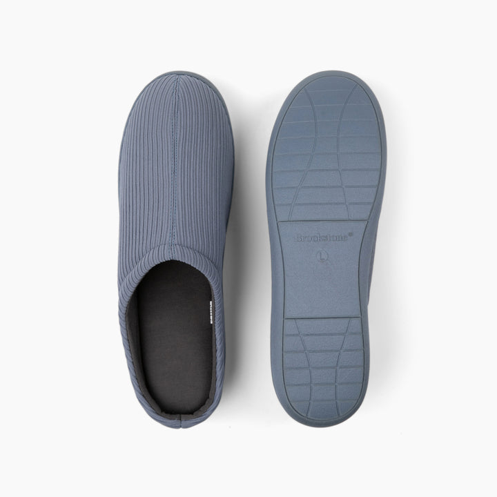 Blue slip-on shoes with textured sole on a white background