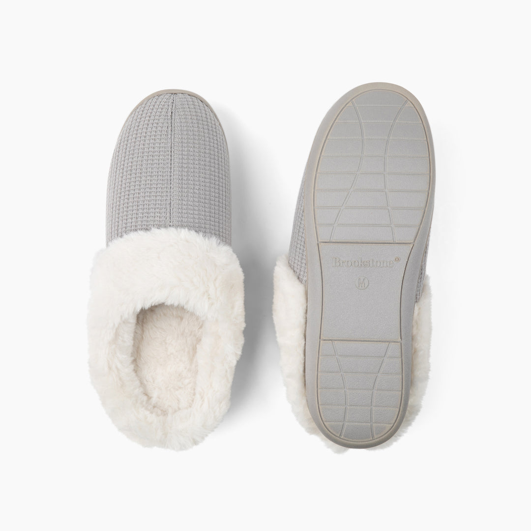Gray slippers with white fur lining on a white background