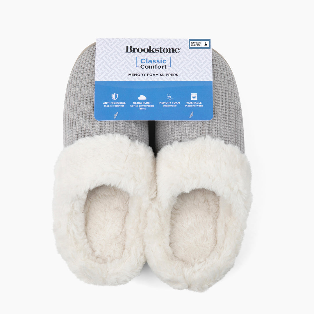 Pair of gray and white slippers with 'Brookstone' label on a white background