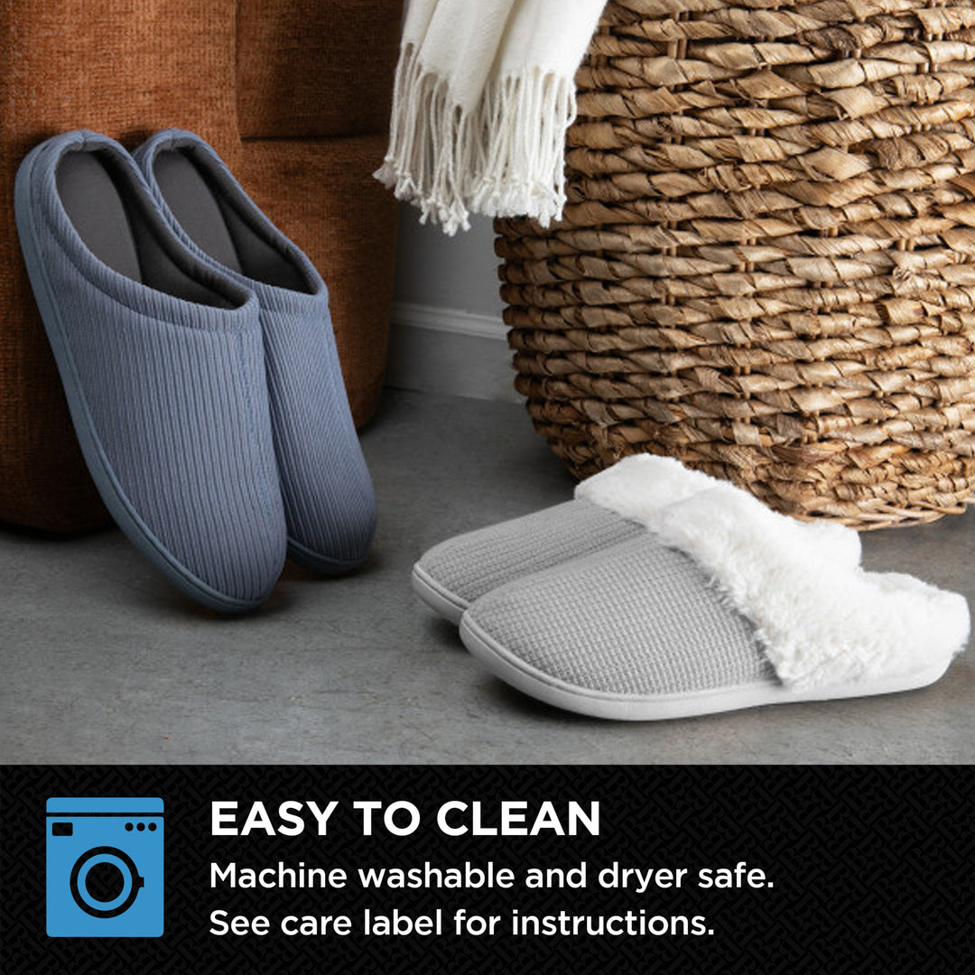 Two pairs of slippers, one blue and one gray with white fur lining, on a carpeted floor next to a woven basket.