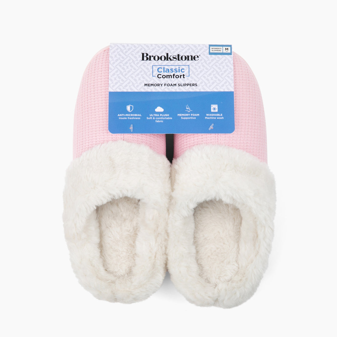 Pair of pink and white slippers with Brookstone packaging on a white background