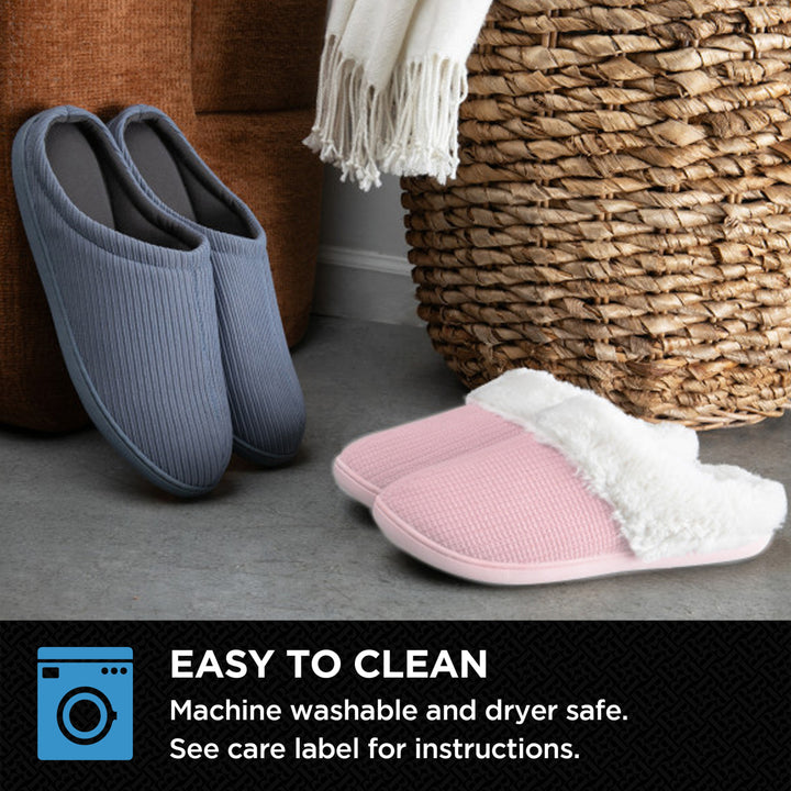 Pair of blue slippers and a pair of pink slippers with white lining on a gray floor next to a woven basket.