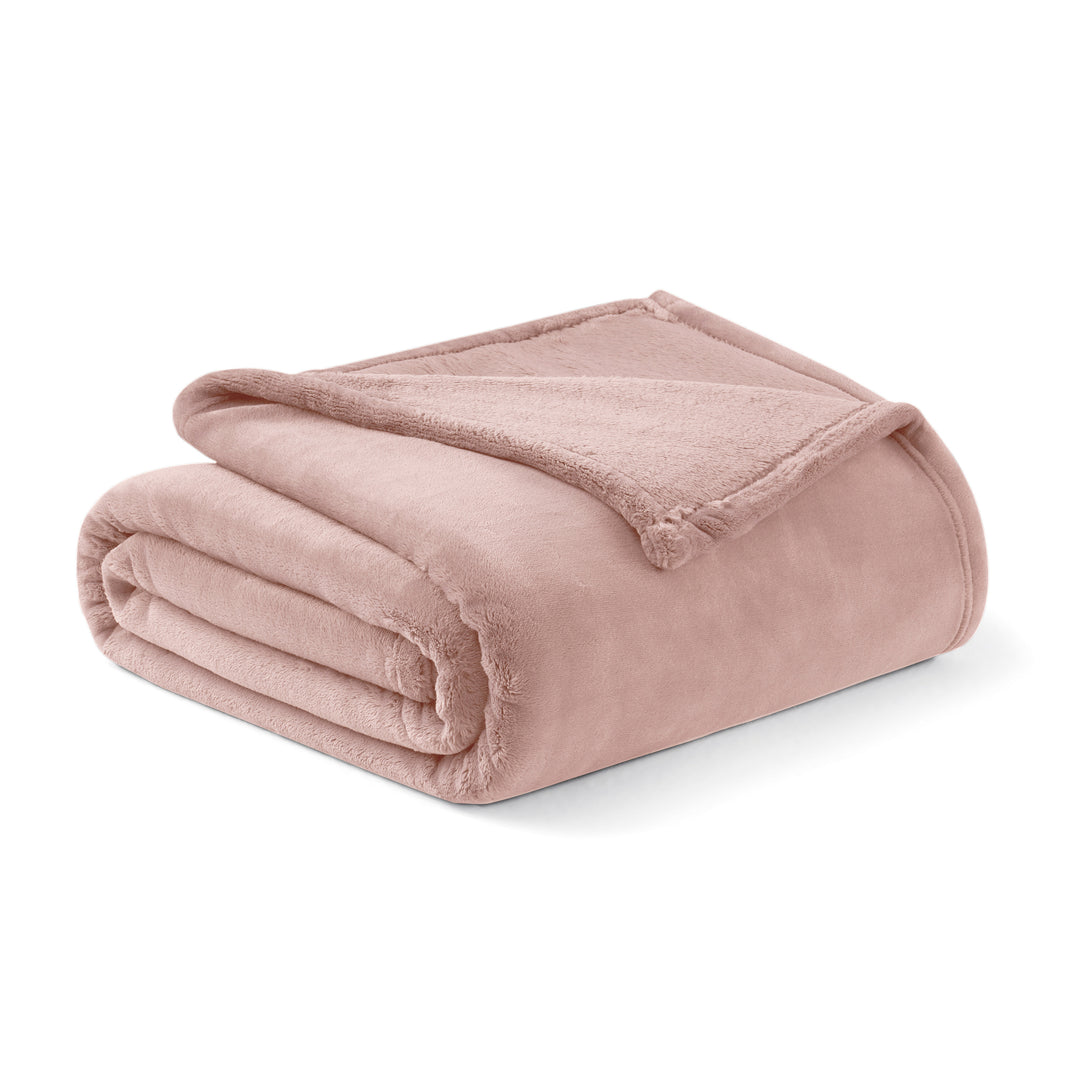 Folded pink blanket on a white background