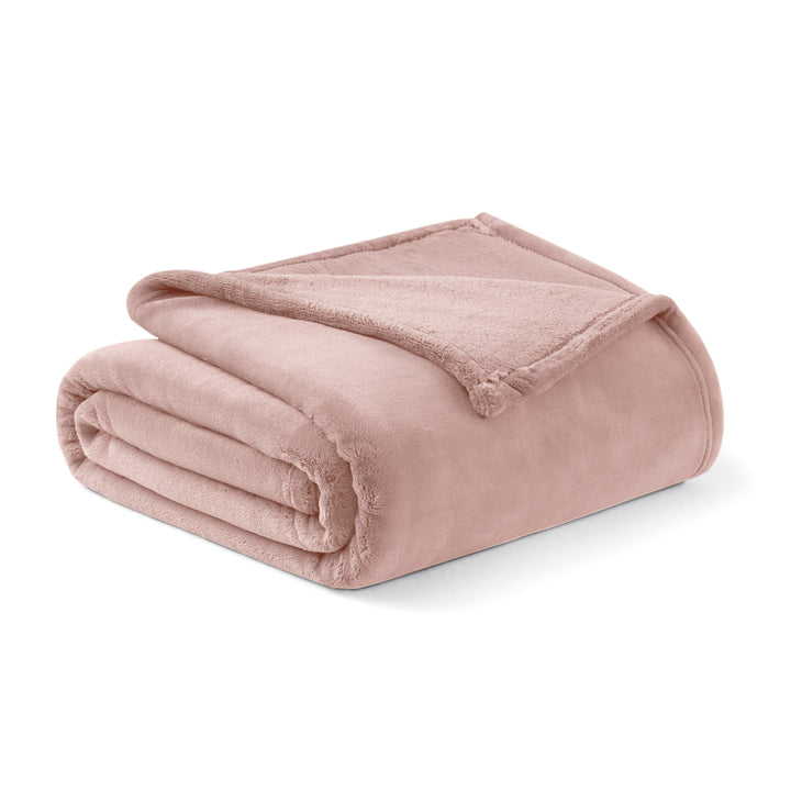 Folded pink blanket on a white background