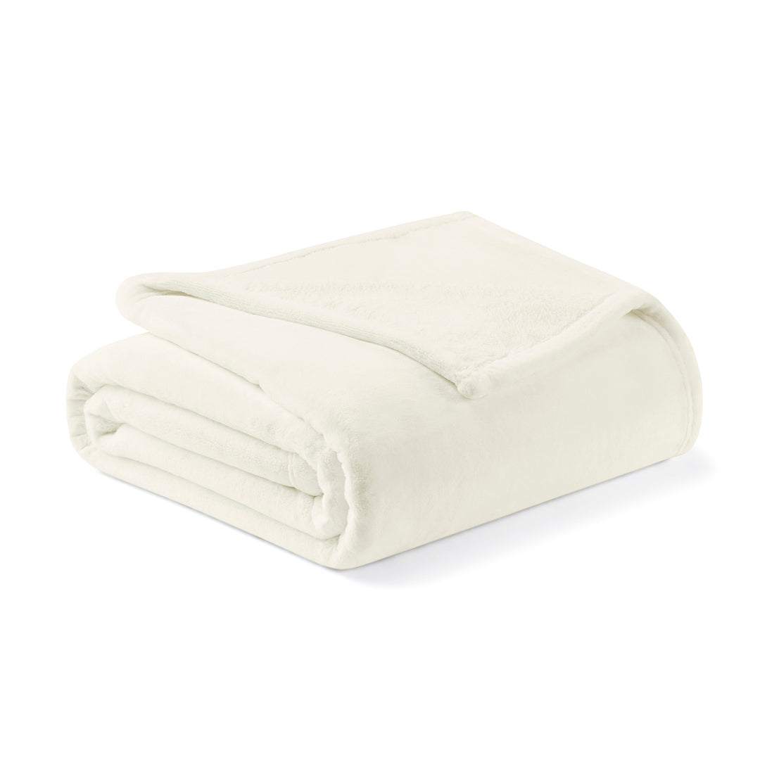 Folded cream-colored blanket on a white background