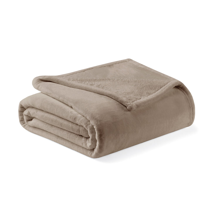 Folded beige blanket on a white background
