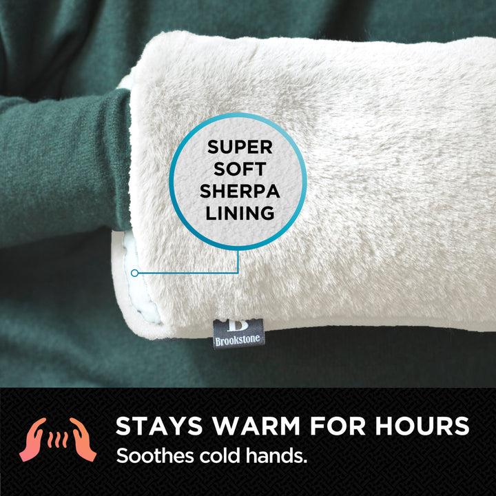 White hand warmer with 'Super Soft Sherpa Lining' label, held by a person wearing a green sleeve.