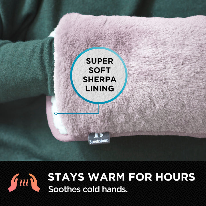 Pink hand warmer with Sherpa lining and Brookstone branding, labeled 'Super Soft Sherpa Lining'.