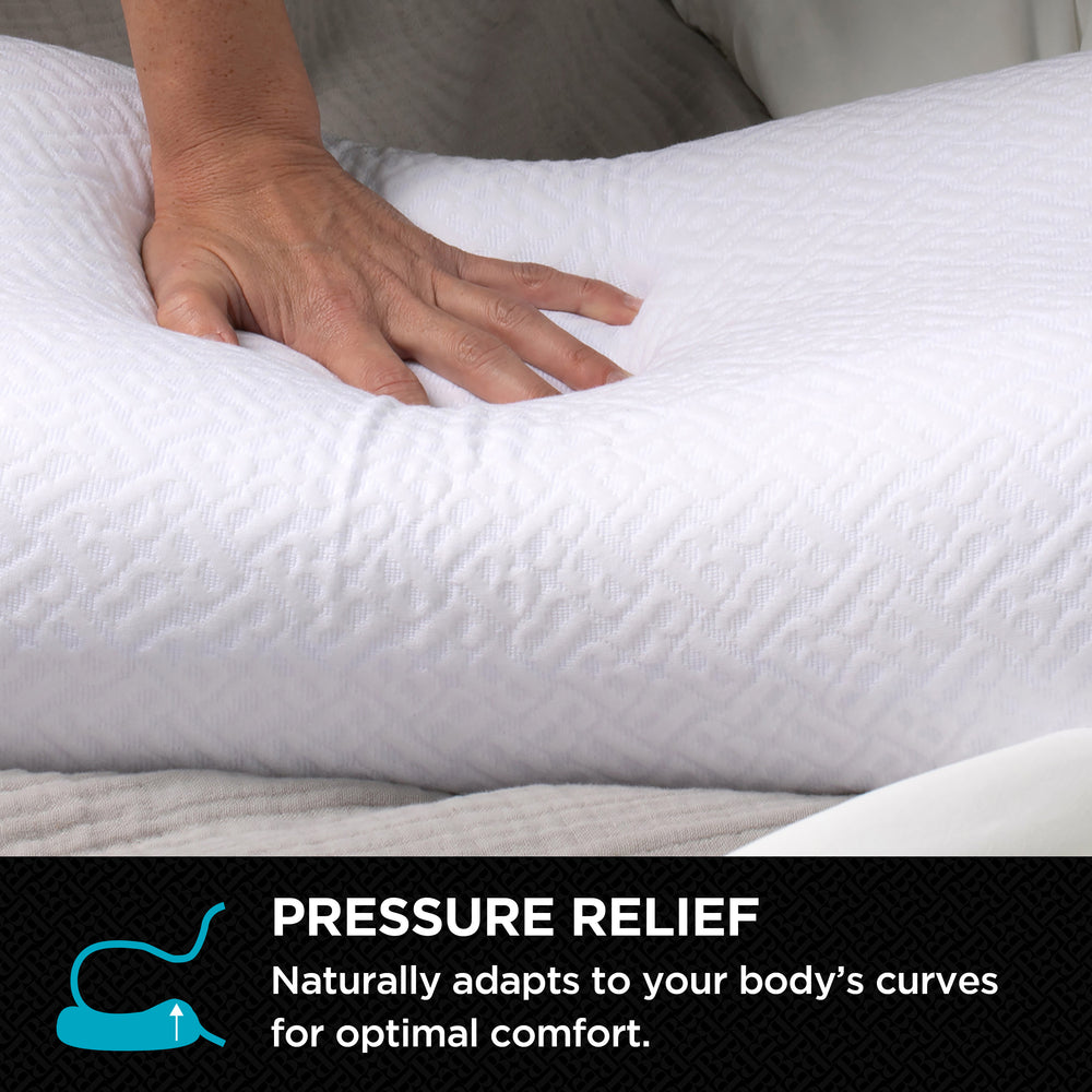 Hand pressing into a white textured pillow to show how it contours for pressure relief.