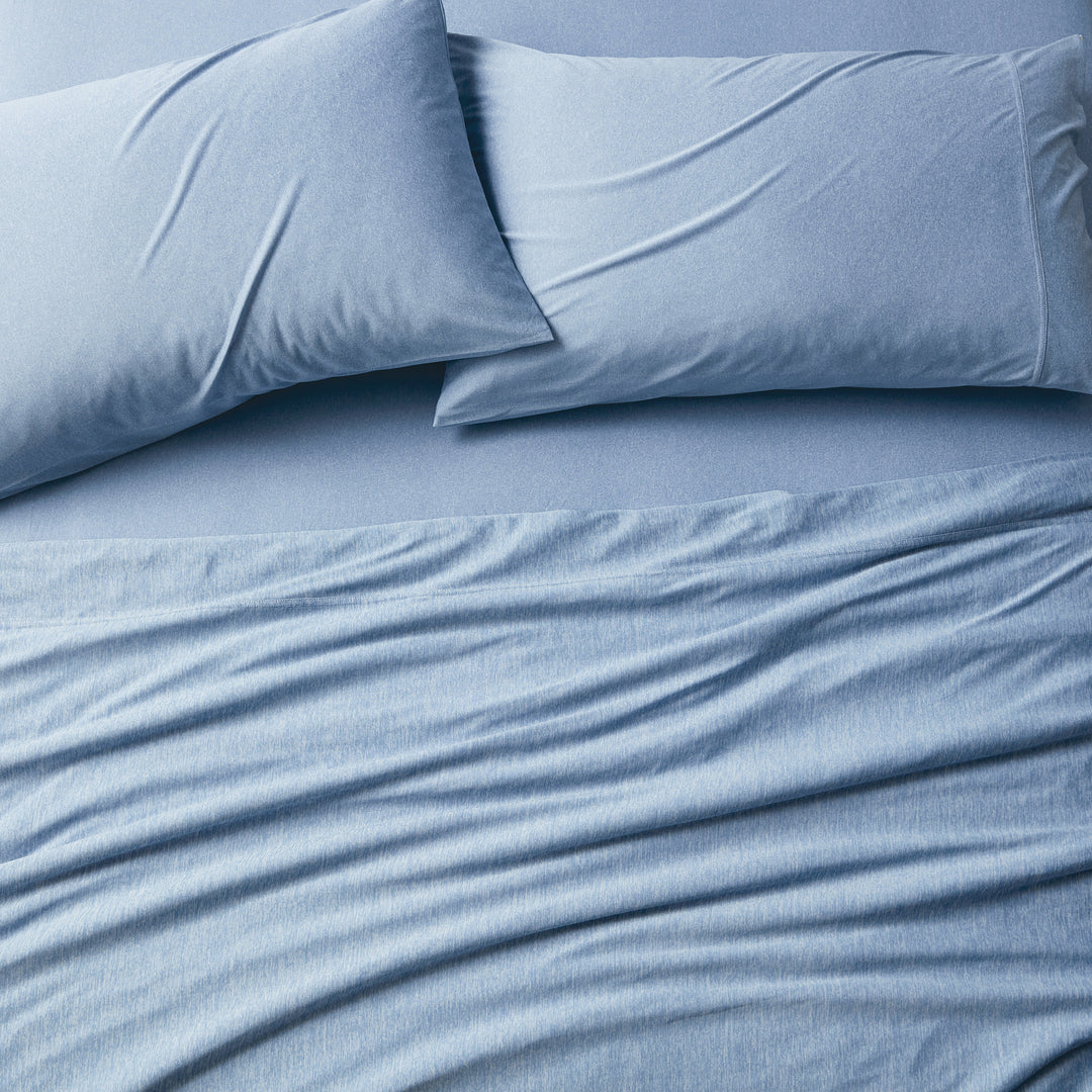 Blue bedding set with two pillows on a bed