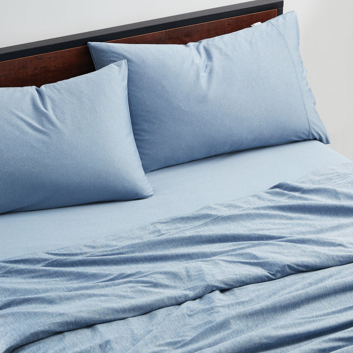 Blue bedding set with pillows on a bed