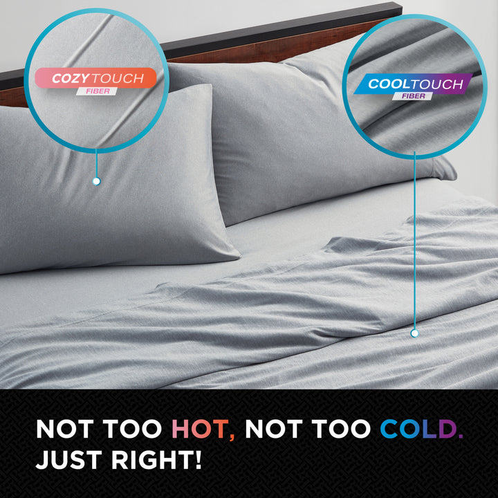 Gray bedding set with Cozy Touch and Cool Touch fiber labels on a bed.
