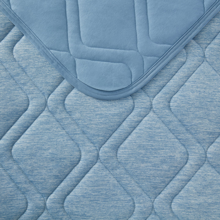 Close-up of a textured blue quilted surface