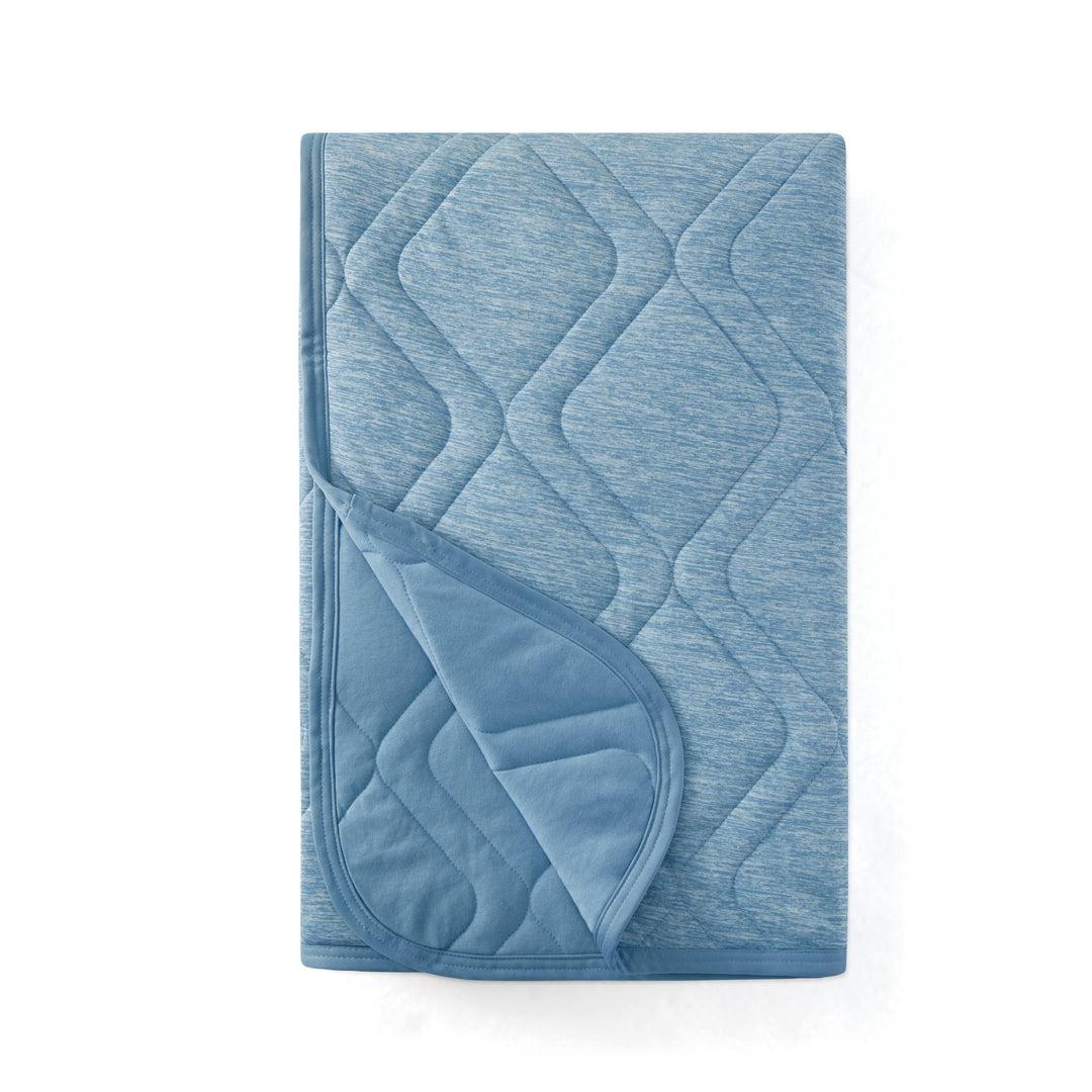 Blue quilted blanket on a white background