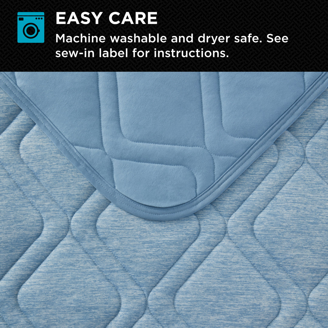 Blue quilted pad with washing and drying information on a black background