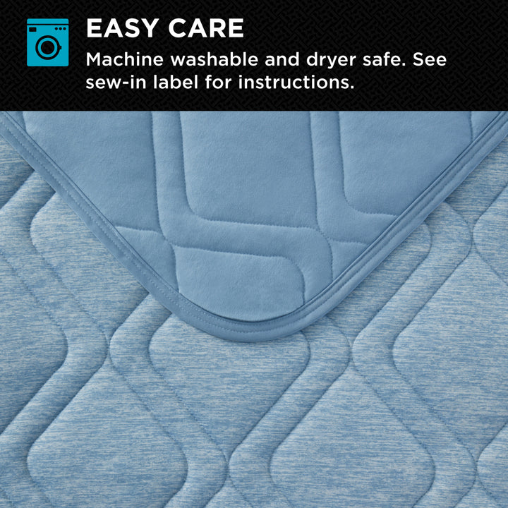 Blue quilted pad with washing and drying information on a black background