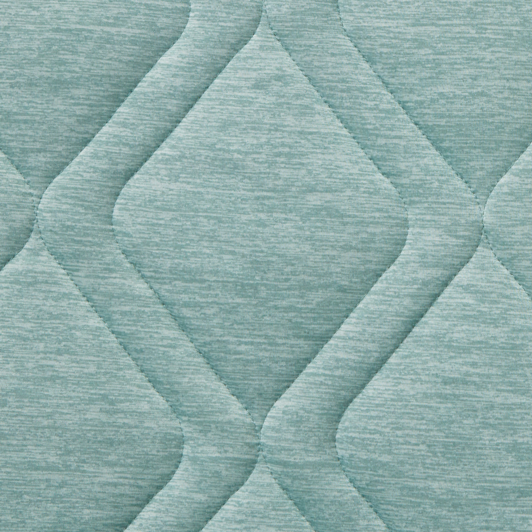 Close-up of textured teal fabric with diamond pattern