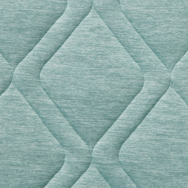 Close-up of textured teal fabric with diamond pattern