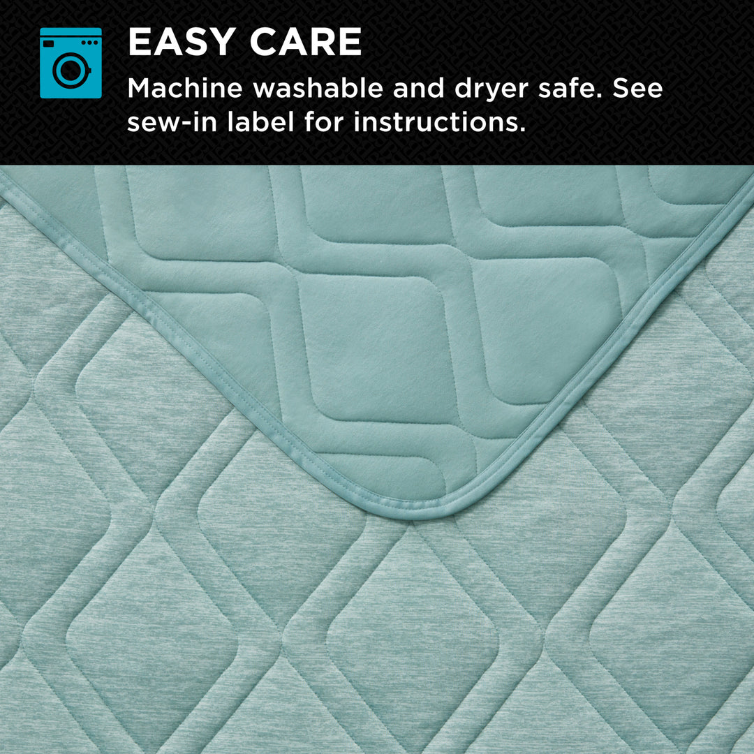 Quilted fabric with diamond pattern and text about ease of care on a black background