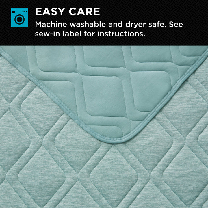 Quilted fabric with diamond pattern and text about ease of care on a black background