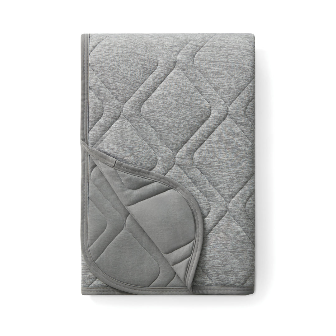 Gray quilted blanket on a white background