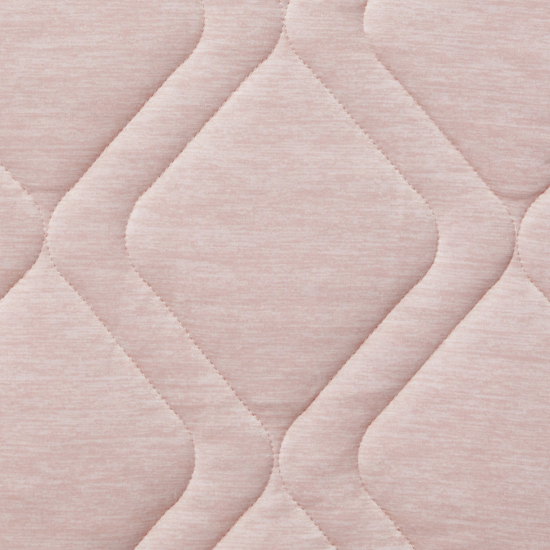 Close-up of a textured pink fabric with wavy pattern