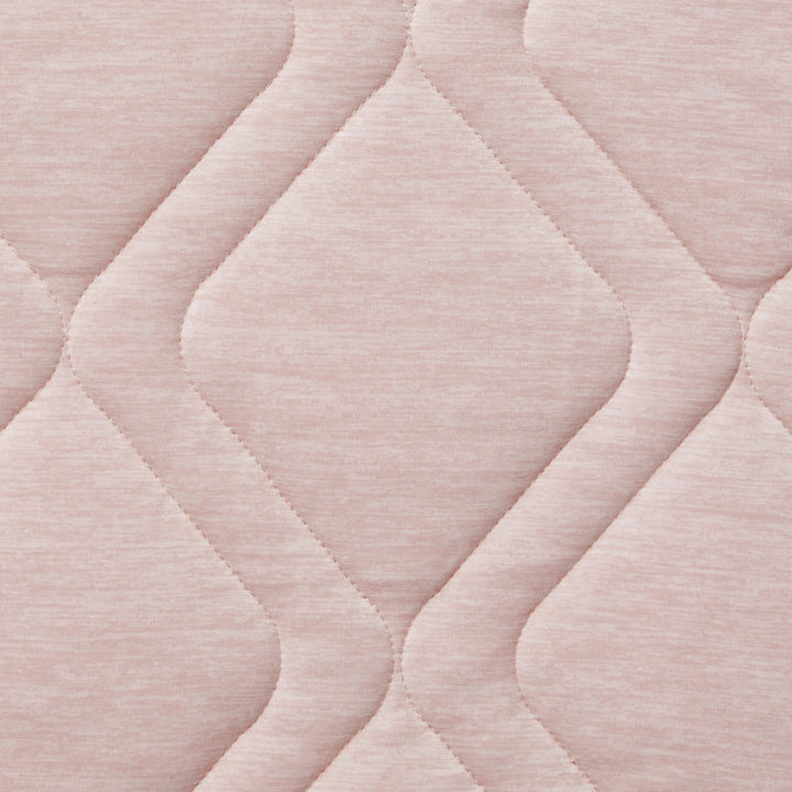 Close-up of a textured pink fabric with wavy pattern