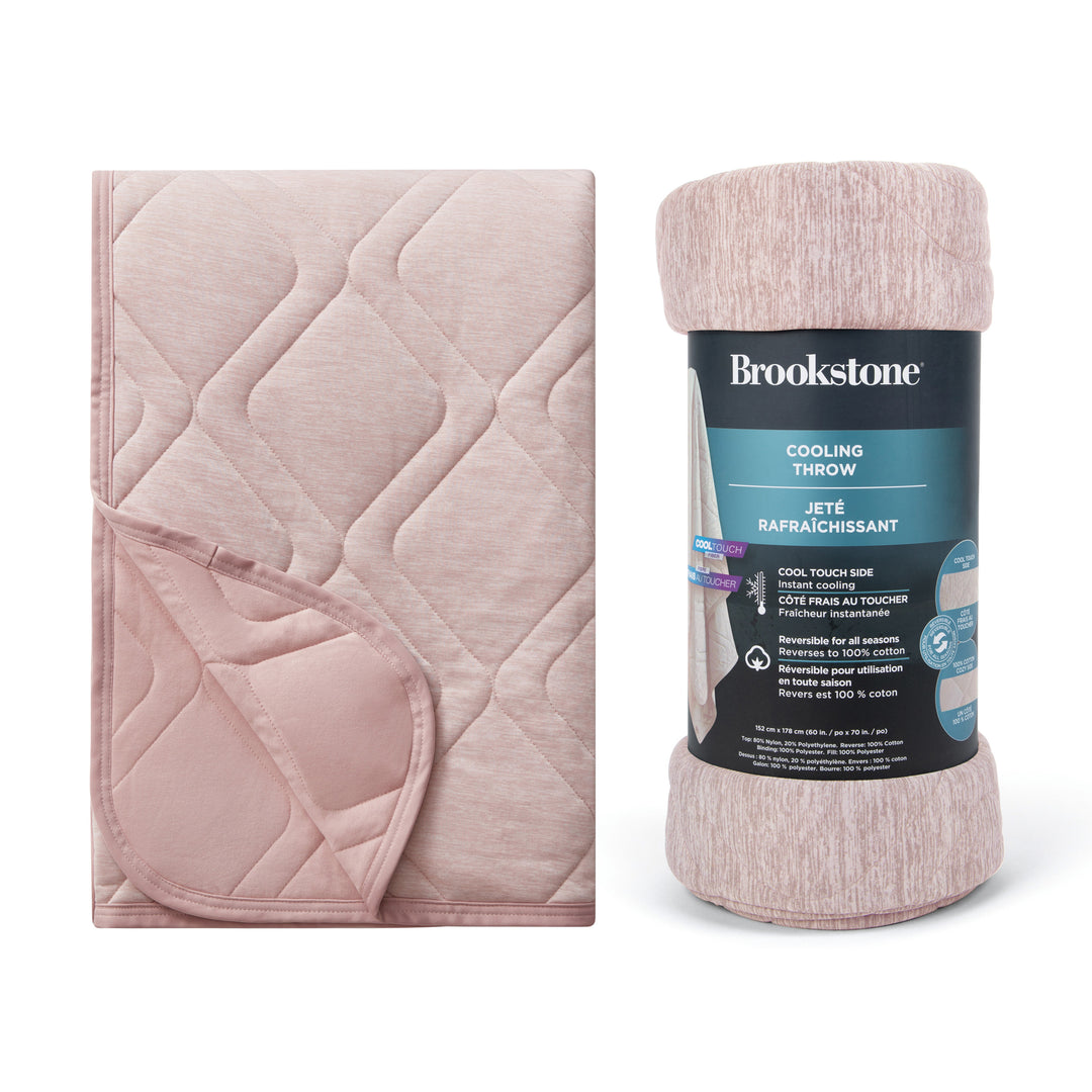 Pink cooling throw blanket with Brookstone packaging on a white background