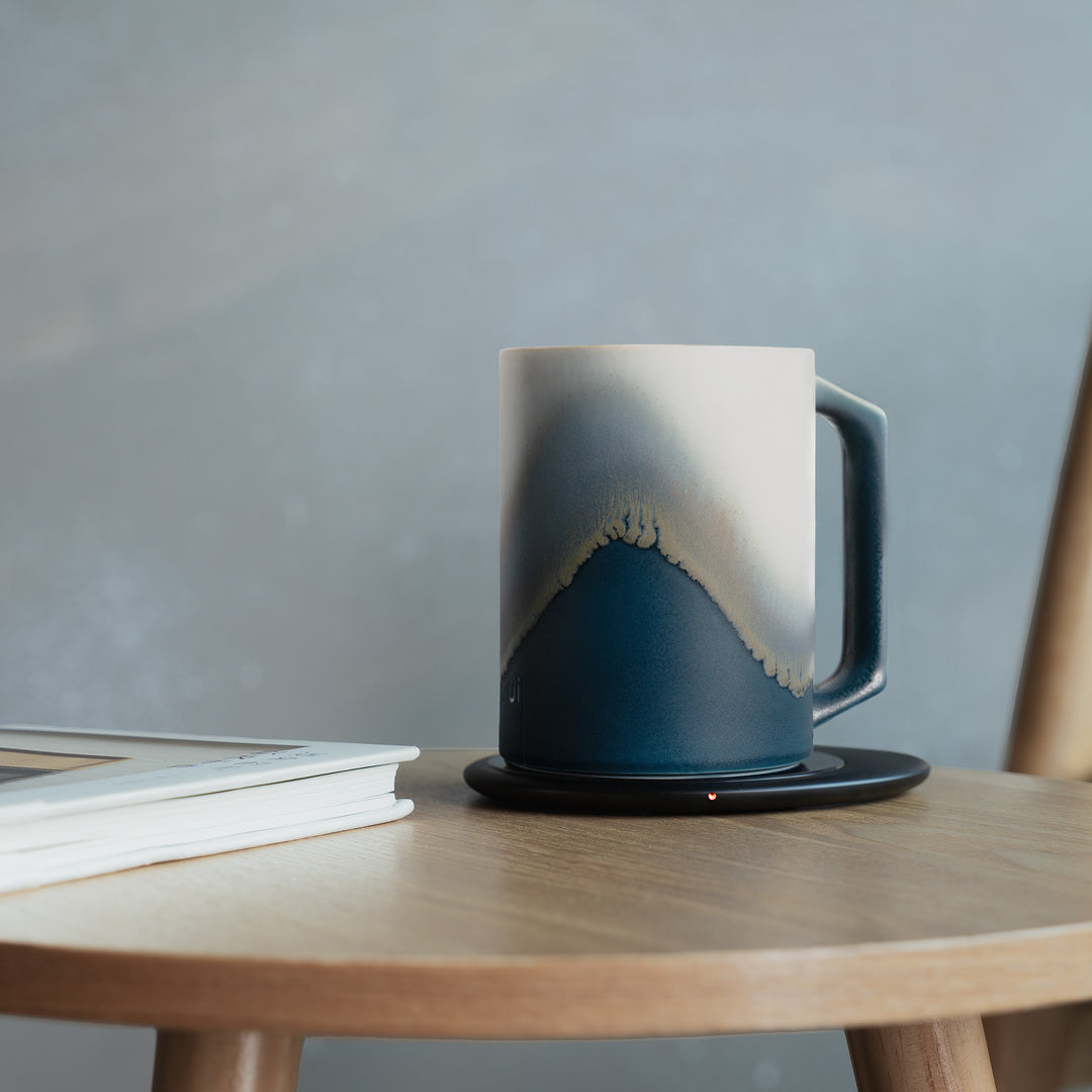 Ceramic mug with gradient design on a wooden table