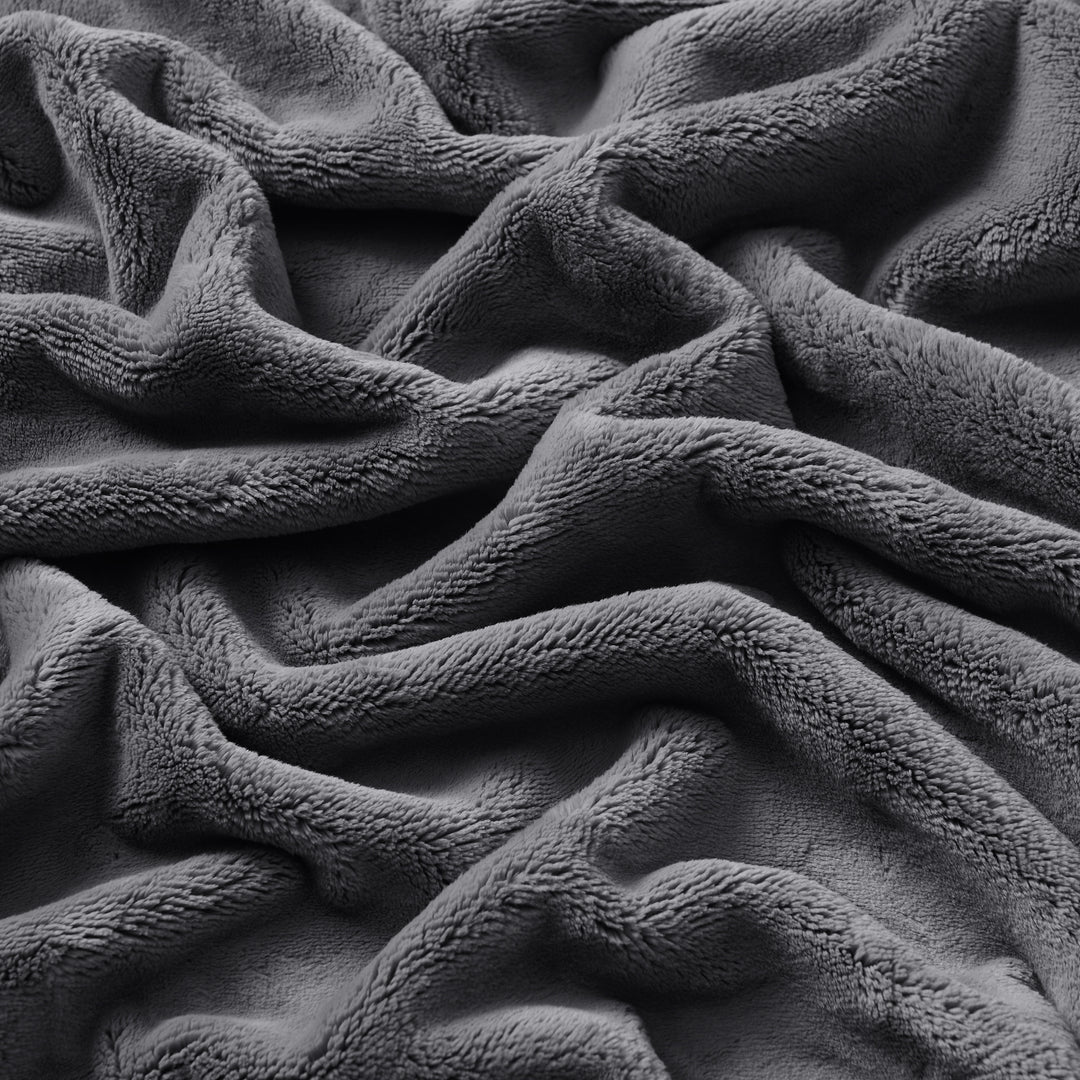 Close-up of the plush, textured surface of the Nap Plush Throw blanket. Silver