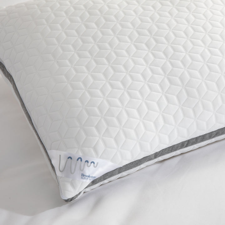 White quilted pillow with gray stitching on a white background