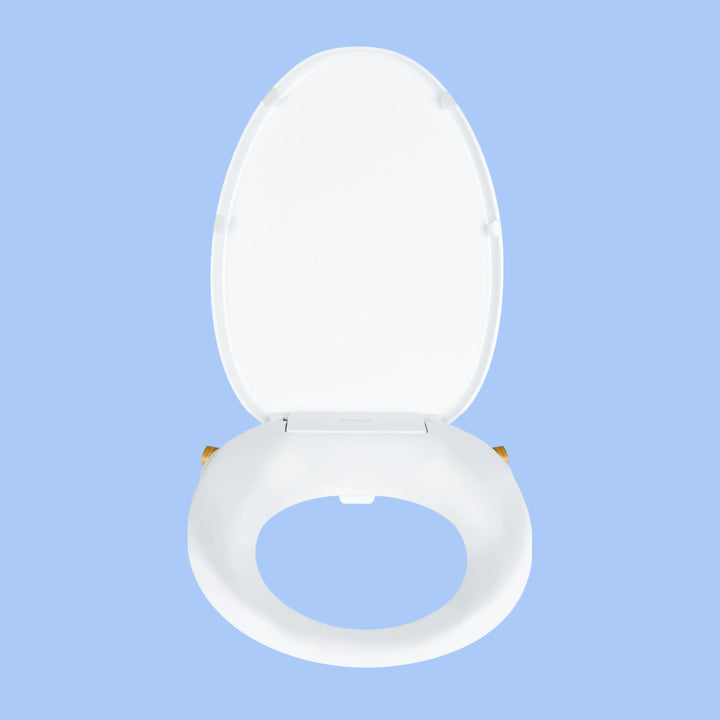 Front view White TUSHY Oasis bidet seat, with bamboo control knobs, on a blue background
