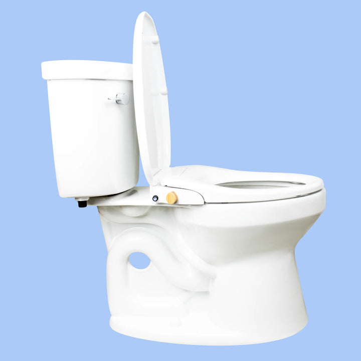 Side view of a toilet with a TUSHY Wave bidet seat, lid open, with a bamboo control knob, on a blue background 