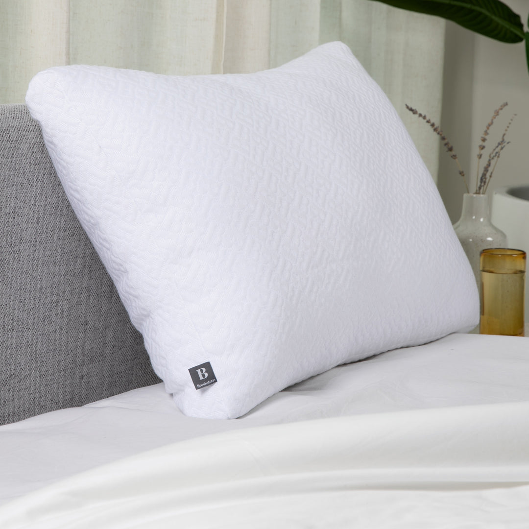 White pillow on a bed with a blurred background