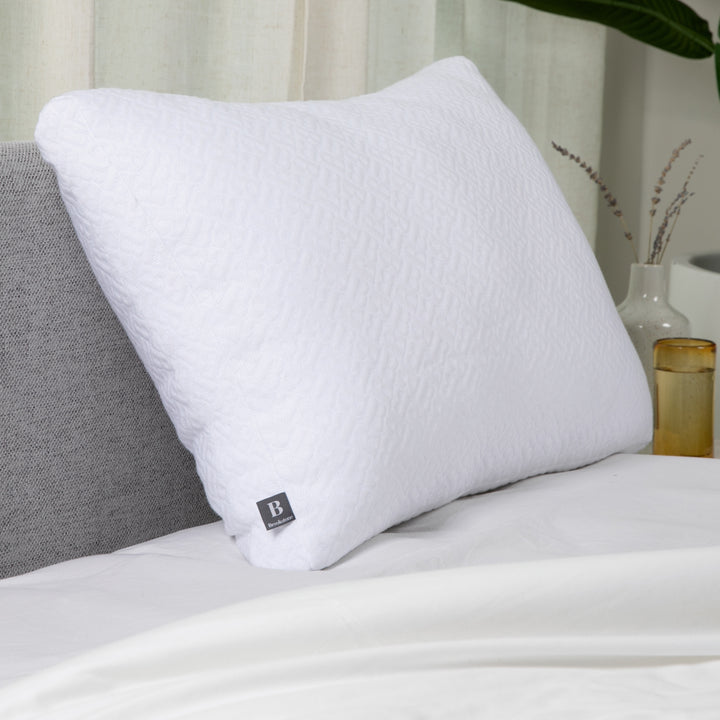 White pillow on a bed with a blurred background