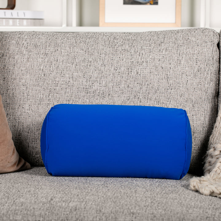 Blue cylindrical pillow on a gray couch in a living room setting