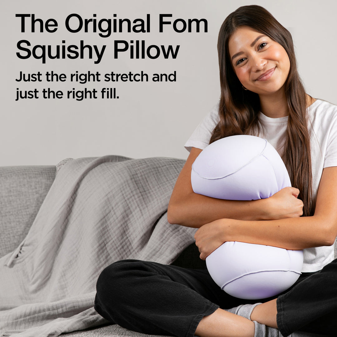Woman holding a squishy pillow with promotional text on a gray background