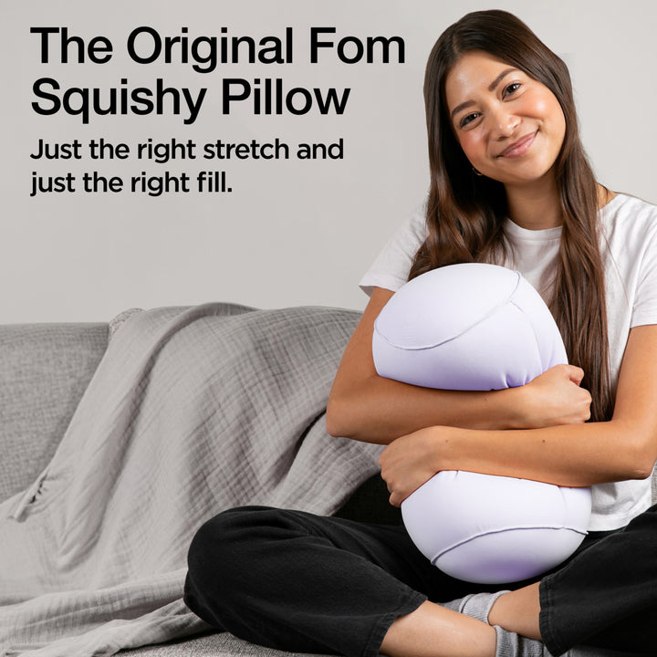 Woman holding a squishy pillow with promotional text on a gray background