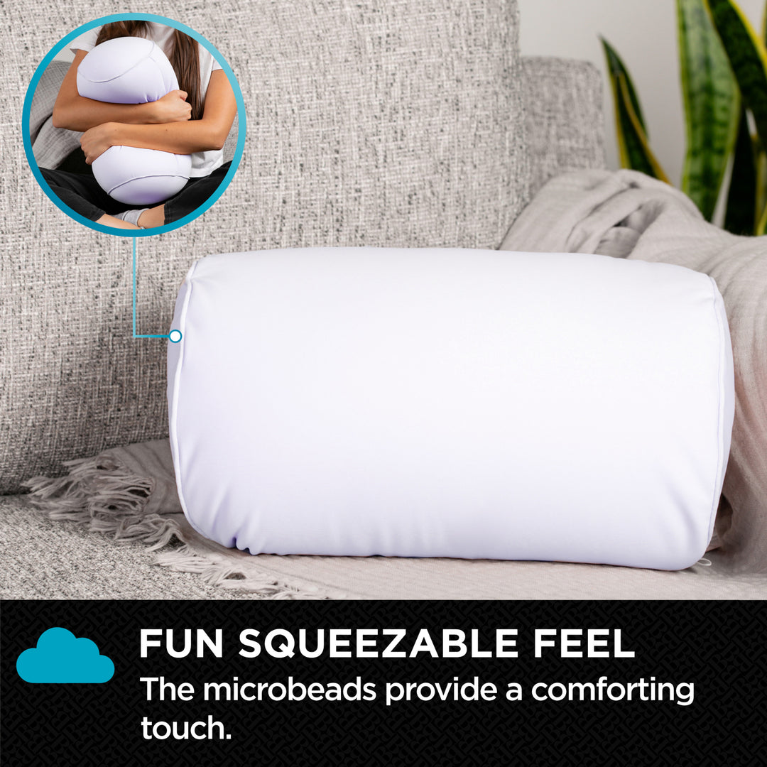 White squeezable pillow on a couch with text about microbeads providing comfort.