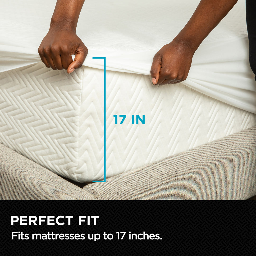 Mattress topper with measurement label showing 17 inches, held by a person.