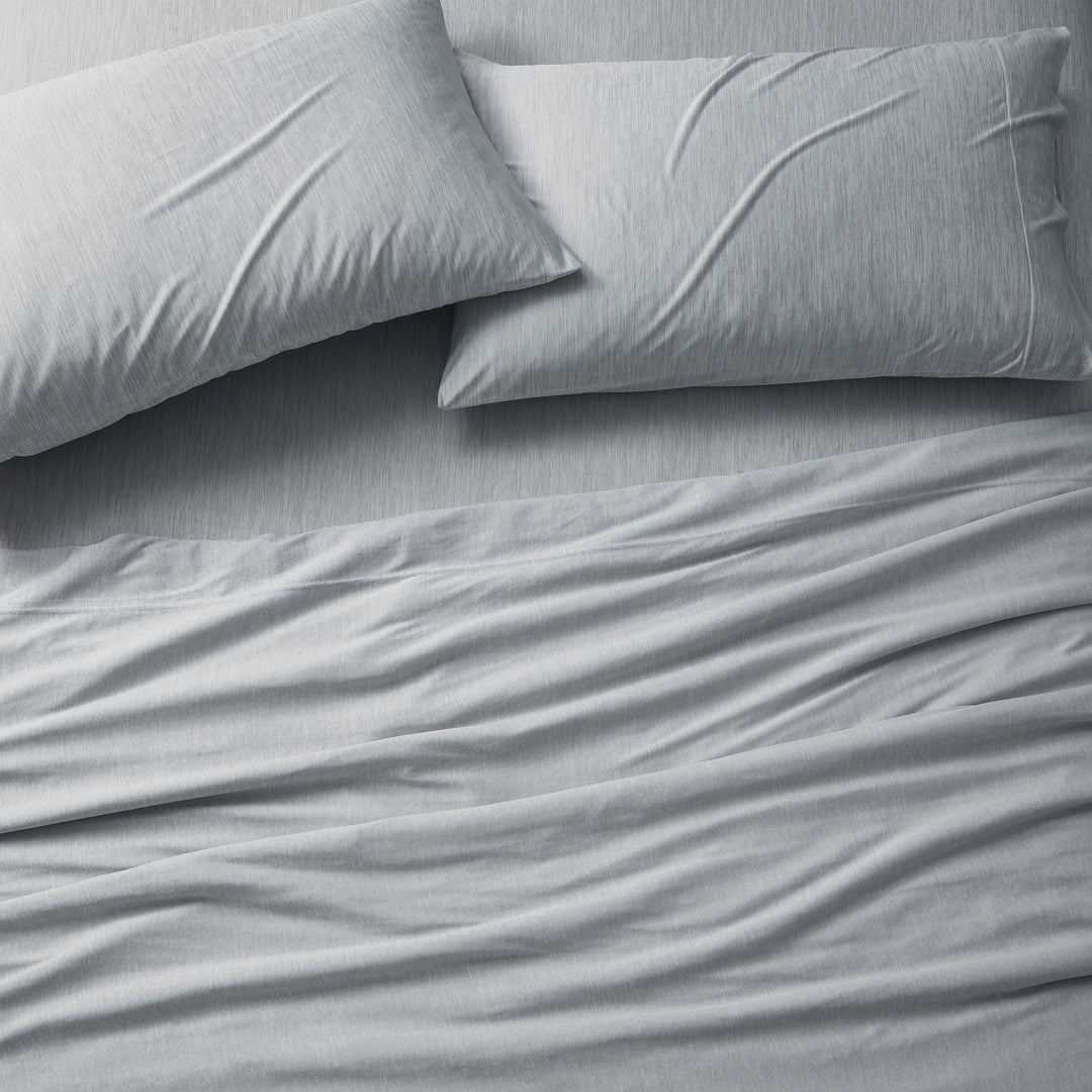 Gray bedding set with two pillows on a bed.