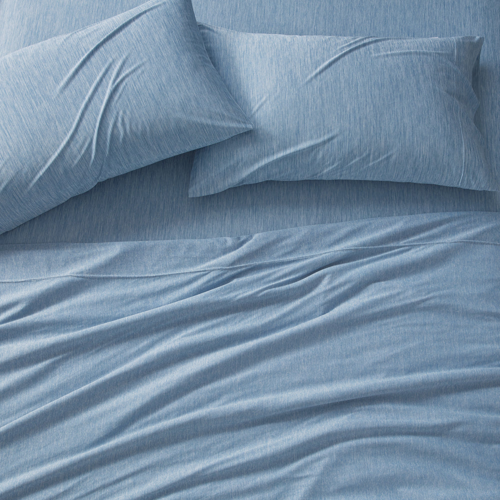 Blue bedding set with pillows on a bed