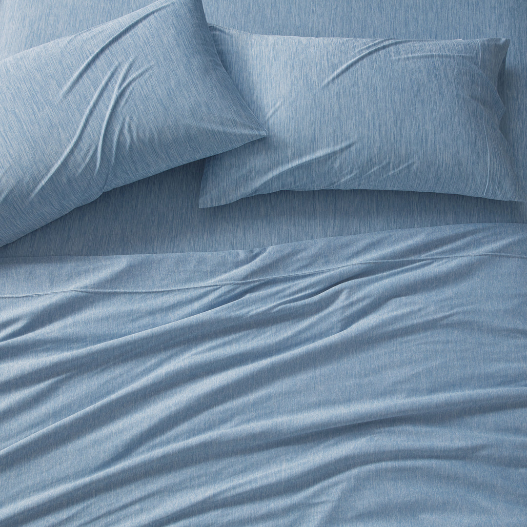 Blue bedding set with pillows on a bed
